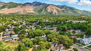 Aerial view of property and surrounding area featuring nearby suburban area and mountains
