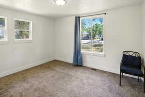 Primary Bedroom featuring an en suite bathroom carpet floors and baseboards