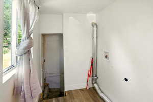 Washroom featuring electric dryer hookup, hookup for a washing machine, and wood finished floors