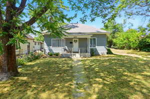 Bungalow-style house with covered porch and roof with shingles