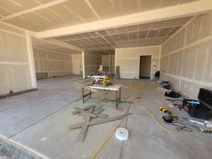 Misc room featuring a garage and concrete flooring