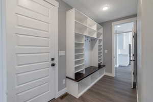 Mudroom with baseboards and dark wood finished floors