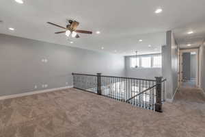 Spare room featuring carpet floors, ceiling fan, and recessed lighting
