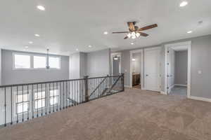 Carpeted spare room featuring a ceiling fan and recessed lighting