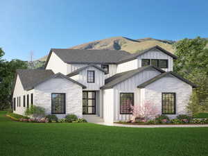 Modern farmhouse style home featuring a shingled roof, a front yard, stone siding, and board and batten siding
