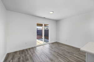 Spare room with wood finished floors and baseboards