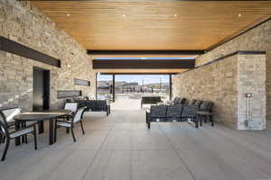 View of patio / terrace featuring an outdoor living space with a fireplace and outdoor dining area
