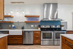 Kitchen with stainless steel appliances, wall chimney range hood, open shelves, cherry cabinets