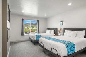 Ensuite bedroom #6 with 2 queen beds, TV, and electric fireplace
