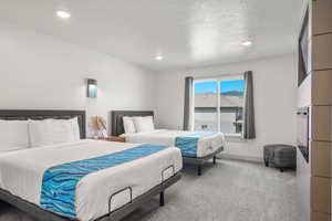 Ensuite bedroom #5 with 2 queen beds, TV, and electric fireplace