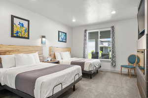 Ensuite bedroom #1 with 2 queen beds, TV, and electric fireplace