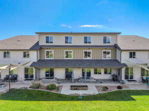 Rear view of house with patio, fire pit and lawn