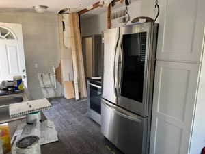 Kitchen with stainless steel appliances and dark wood-style floors
