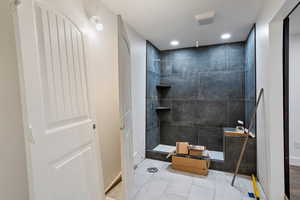 Full bath with walk in shower, recessed lighting, and tile patterned flooring