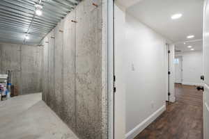 Hallway with baseboards and wood finished floors