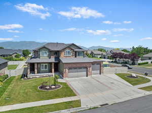 View of front of property with a gate, driveway, a mountain view, and a residential view