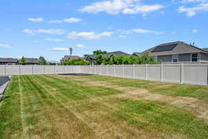 Fenced backyard featuring a residential view