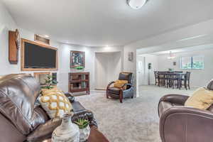 Living room with carpet flooring and a textured ceiling