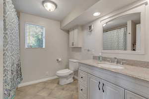 Bathroom with vanity, a textured ceiling, and tile patterned floors