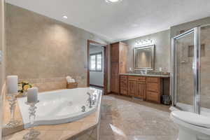 Primary bedroom ensuite bath with gorgeous cabinetry, jetted-tub and large walk-in closet