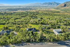 View of property location with a mountainous background and a heavily wooded area