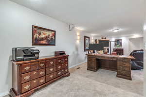 Office with carpet floors and baseboards