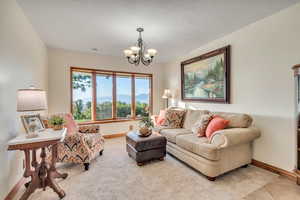 The living room boasts sweeping panoramic valley, mountain and lake views