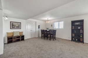 Dining area featuring a textured ceiling and carpet floors