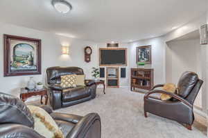 Carpeted living room with baseboards