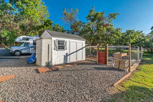 Storage shed and fenced garden area