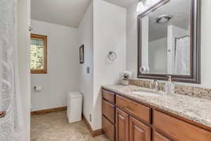 Main level bath with toilet and vanity
