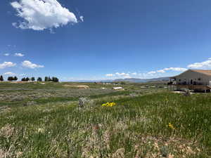 View of yard featuring a view of rural / pastoral area and a mountain view