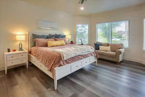 Bedroom featuring dark wood-style floors and recessed lighting