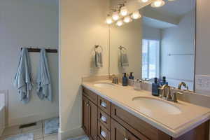 Bathroom with tile patterned flooring and double vanity
