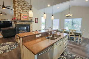 Kitchen with dishwasher, ceiling fan, dark wood finished floors, a kitchen island with sink, and recessed lighting