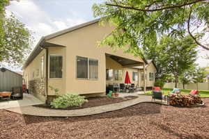Rear view of property featuring a patio and stucco siding