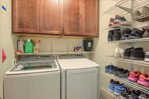 Laundry room with washing machine and clothes dryer and cabinet space