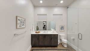 Full bathroom featuring vanity, a stall shower, decorative backsplash, and recessed lighting