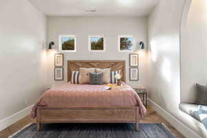 Bedroom featuring baseboards and arched walkways
