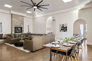 Dining area with arched walkways and ceiling fan