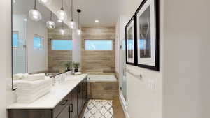Bathroom featuring vanity, a stall shower, and a bath