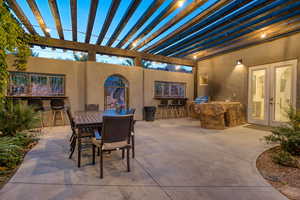 View of patio with an outdoor kitchen, outdoor dining space, and a pergola
