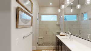 Full bathroom featuring vanity and a shower stall