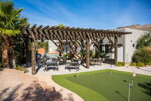 View of community featuring an area to practice putting, a pergola, and a patio