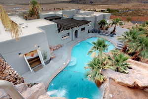 View of pool with a mountain view and a patio