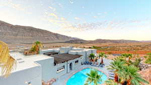 View of pool with a mountain view and a patio area