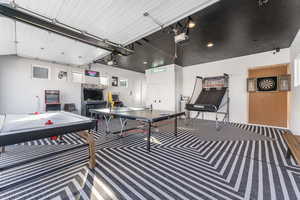 Recreation room featuring a garage and carpet