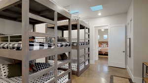 Bedroom with a skylight and recessed lighting