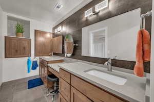 Full bath featuring vanity and tile patterned flooring