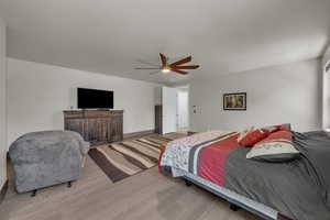Bedroom featuring light wood-style floors and ceiling fan